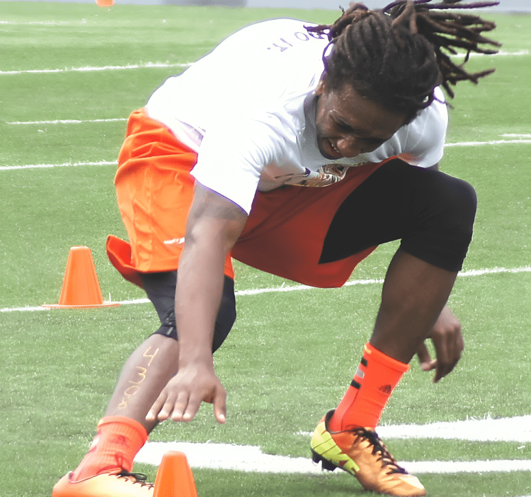 Athlete practicing agility drills on field.