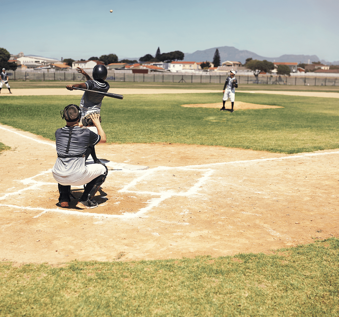 Baseball player swinging bat during game.