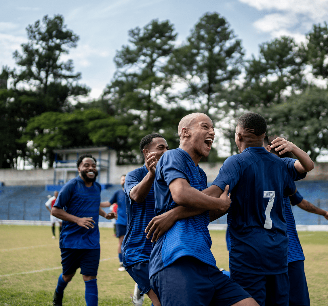 Soccer team celebrating on the field.