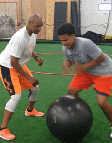Two men exercising with a stability ball.